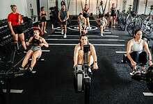 Indoor rowing athletes using data-driven testing methods at a modern gym.