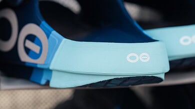 Close-up of blue and black running shoes and gear on display at Running Insights store, highlighting athletic footwear and accessories for runners.
